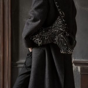 Model wearing a black heavy metal hardware moto shoulder bag