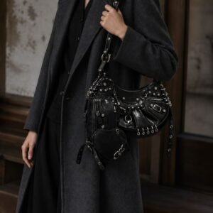 Model wearing a black pierced-stud crescent shoulder bag